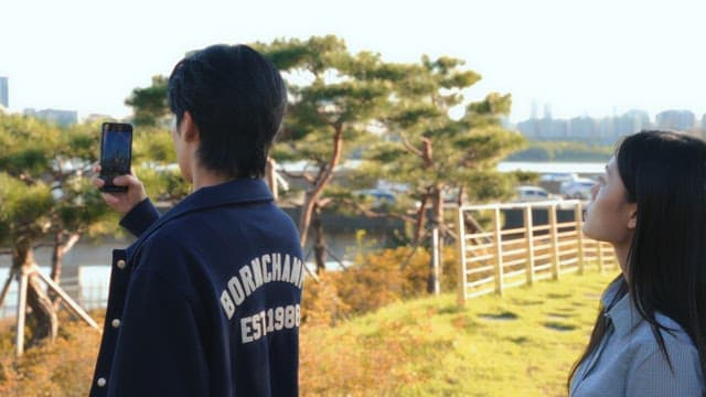 Couple taking landscape photos on a sunny day