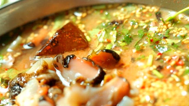 Close-up of fresh top shell cold raw fish soup