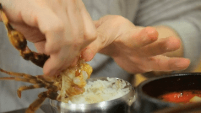 Eating marinated crab with rice