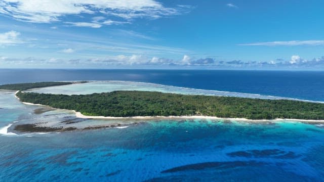 Aerial view of a tropical island surrounded by blue ocean
