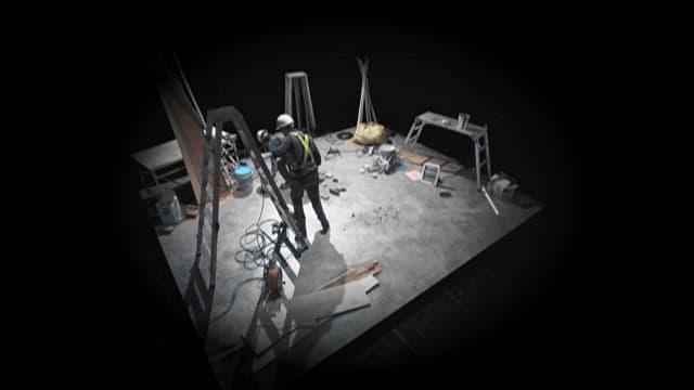 Workers Operating in a Dimly Lit Workshop