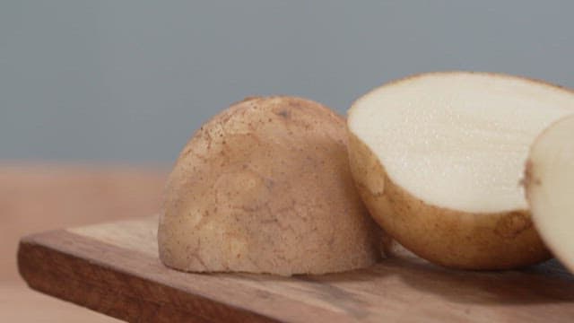 Cut Potatoes on a Wooden Board