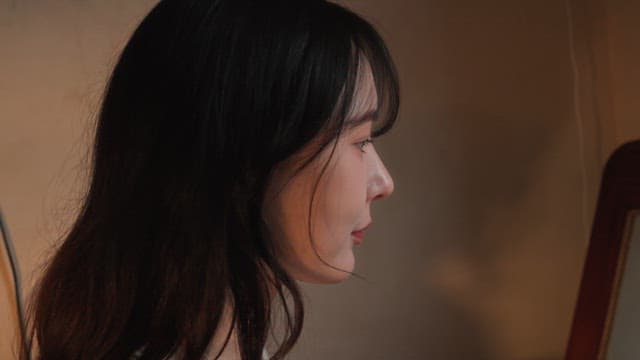 Woman applying skincare indoors