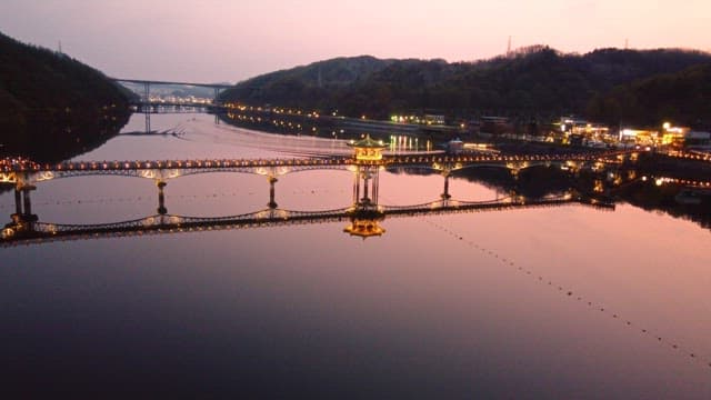 Beautifully lit bridge over a calm river