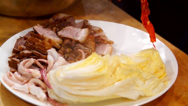 Boiled pork and swordtip squid salad, cabbage on the dish