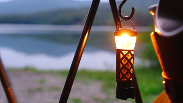 Illuminated camping lantern with lake and mountains