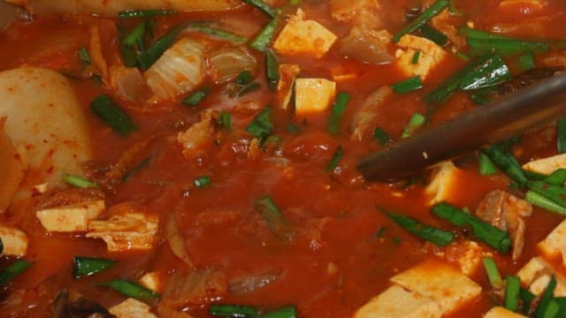 Kimchi stew with generous amounts of pork and tofu