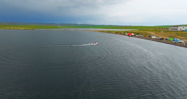 Boat cruising on a scenic lake