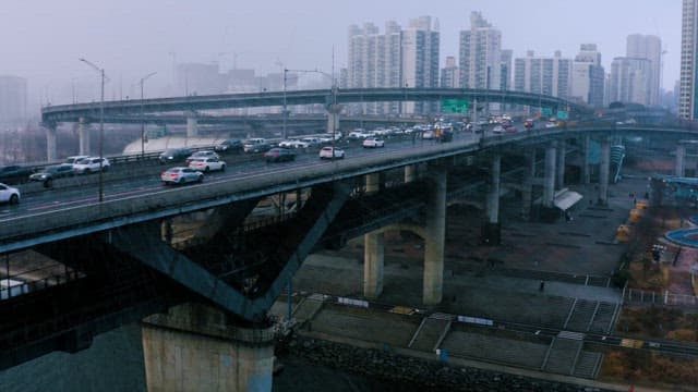 Snowy Overcast Day at a Bustling Urban Overpass