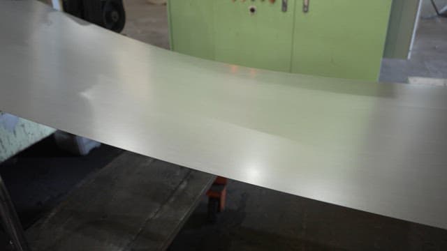 Metal sheet being processed in a factory