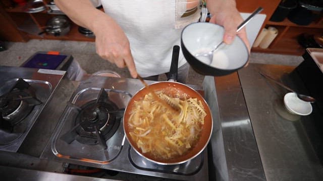 Cooking Bamboo Shoot in a Hot Pan with a Spatula
