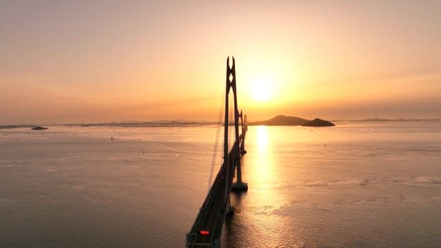 Bridge over the sea at sunset