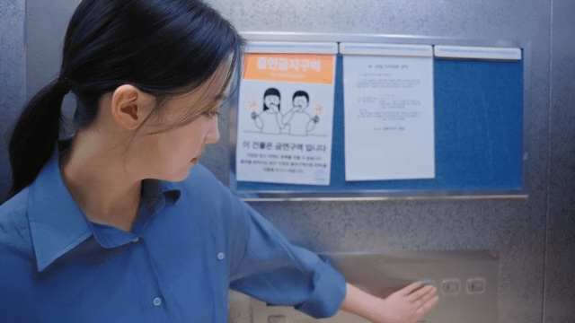 Woman pushing the elevator button