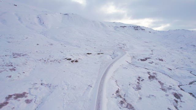 Snow-covered mountain road in winter