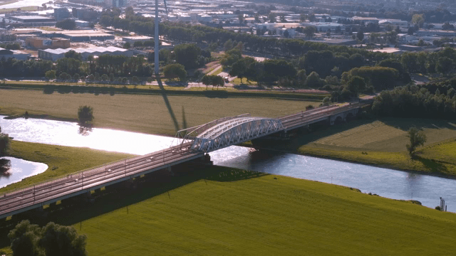 Bridge over a river with green fields