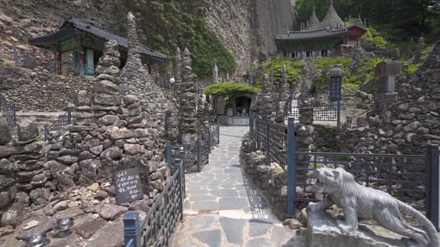 Serene Temple Entrance with Stone Stairs and Statues