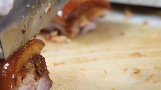 Pig's feet being cut on a cutting board