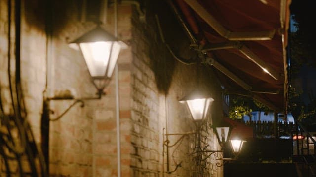Streetlights illuminating a quiet alleyway at night
