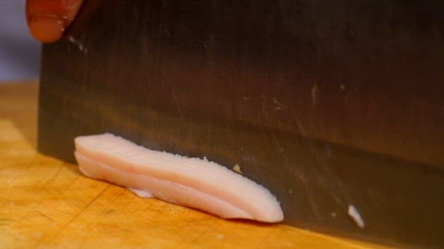 Slicing lard on a cutting board