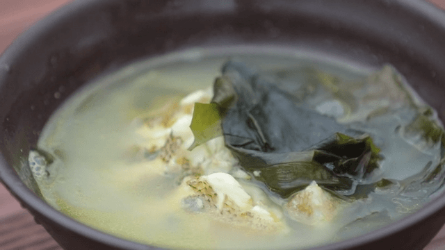 Bowl of warm seaweed soup with flounder