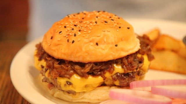 Juicy cheeseburger with caramelized onions