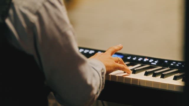 Fingers playing a melody on the keyboard