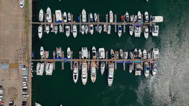 Numerous yachts anchored in the harbor on a clear day