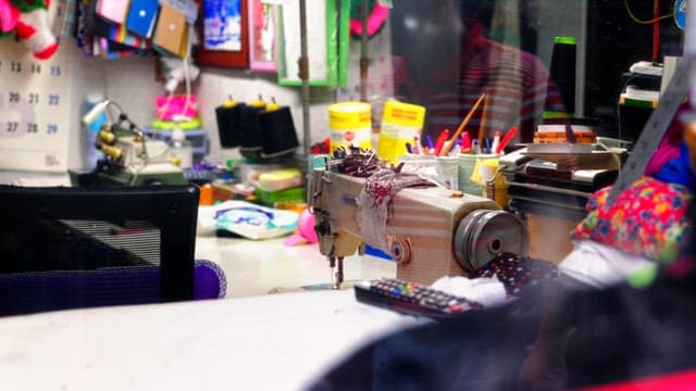 Industrial sewing machine on a cluttered workbench