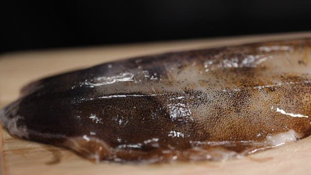 Fresh squid on a wooden cutting board