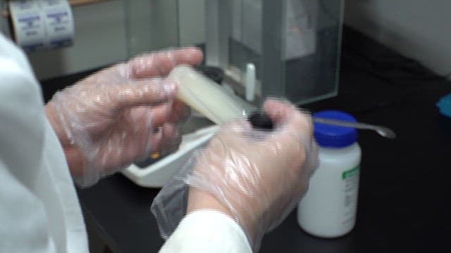 Scientist Testing Solutions in Laboratory