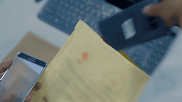 Person Taking out a Smartphone from a Document Bag