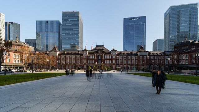 Bustling plaza in front of a historic station
