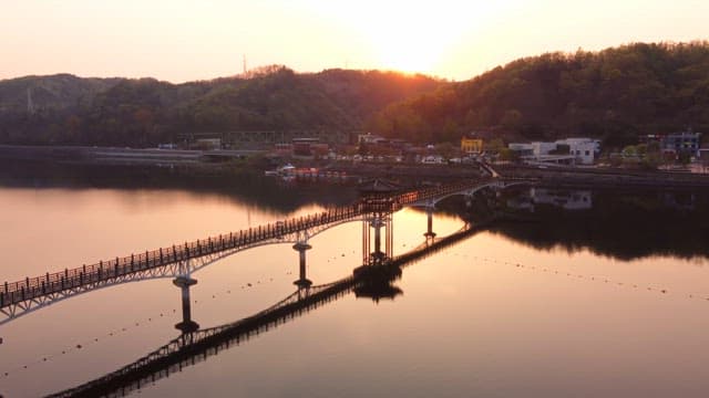 Scenic bridge over a calm river at sunset
