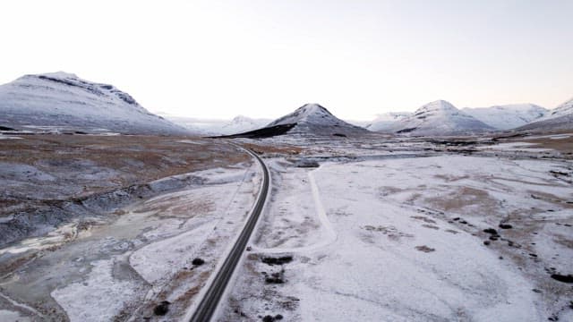 Snowy mountains and road with cars