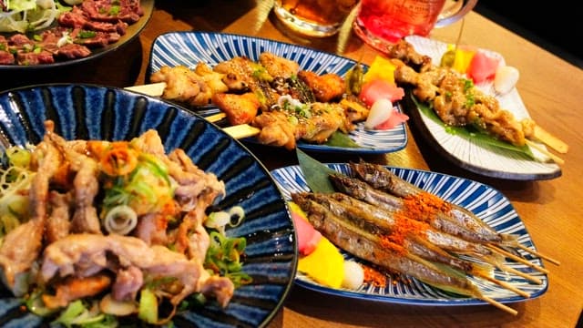 Table generously laid out with a variety of Japanese cuisine