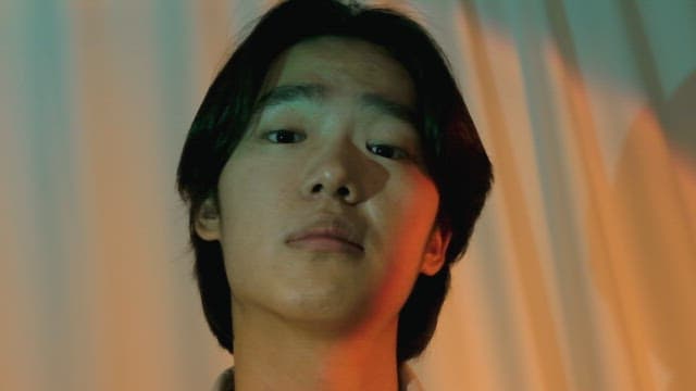 Man sneering in colorful lights