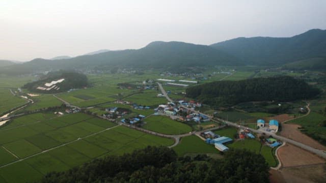 Peaceful rural village surrounded by farmlands
