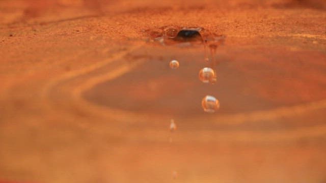 Water droplets falling from the surface of a jar