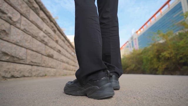A Person Walking Along An Urban Pathway