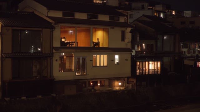 People enjoying dinner at a traditional Japanese restaurant at night