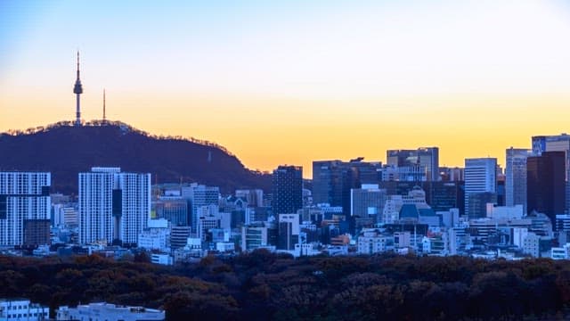City skyline transitioning from sunset to night