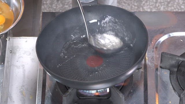 Pouring oil in a frying pan and adding eggs