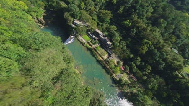 Aerial view of a waterfall and lush forest