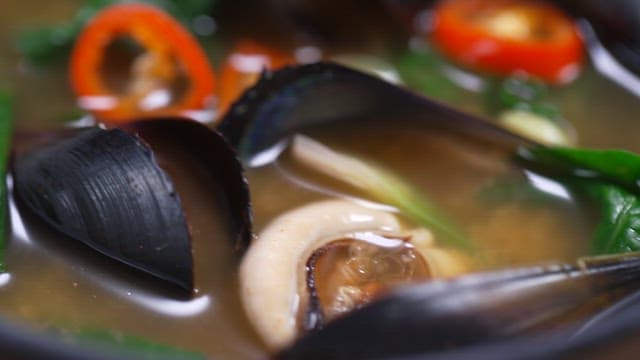 Seafood soup with a rich broth filled with fresh vegetables and mussels