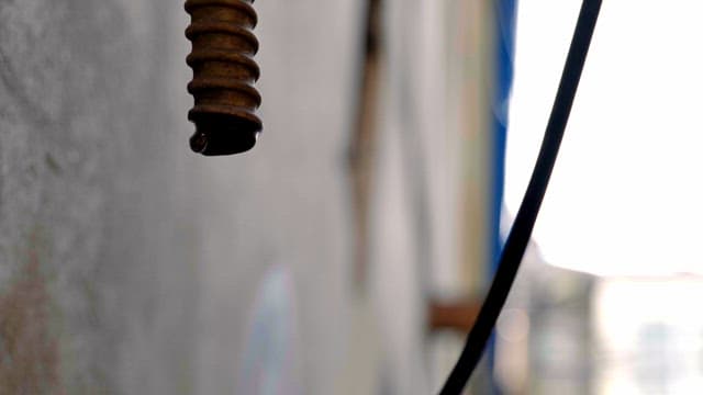 Water drop falling from pipe