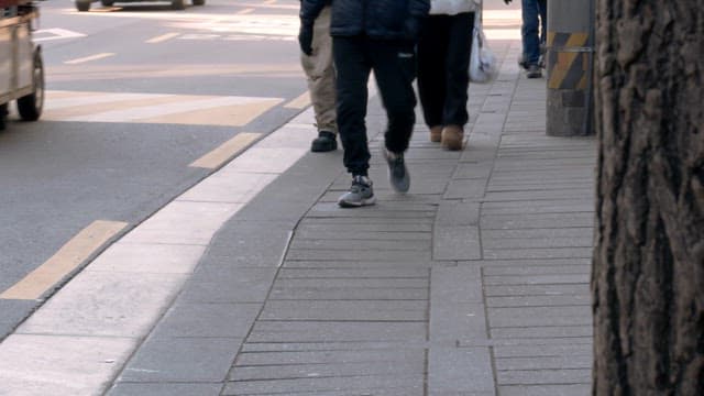 People walking on a city sidewalk