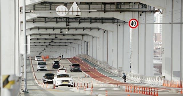 Vehicles and Bicycle Riders Traveling on a Urban Road