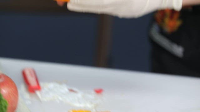 Preparing a fruit dessert with oranges and cherries
