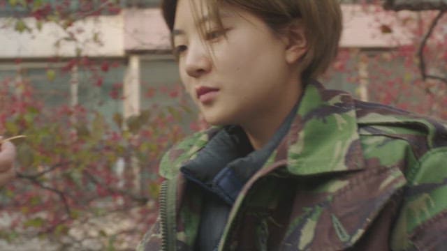 Two people discovering a gold object and looking at it curiously