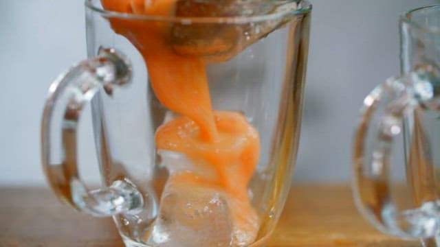 Pouring Fresh Juice into a Glass